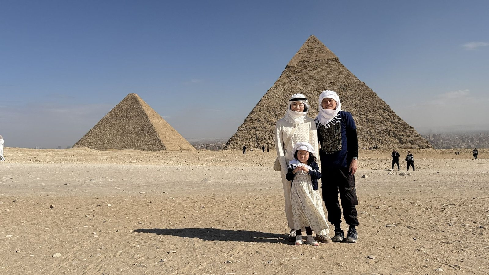 AJ Pardilla with his wife and daughter in front of the pyramids of Giza.
